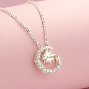 a silver necklace with a star and a moon Vòng cổ bạc